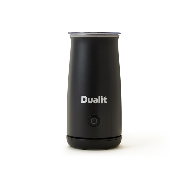 A black Dualit milk frother with a power button on the front, standing upright on a plain white background.