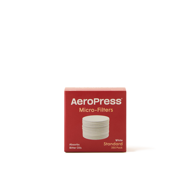 A red box of AeroPress Micro-Filters, labeled Standard, 350 Pack with an image of round white filters on the front. The box states it Absorbs Bitter Oils. The background is plain white.