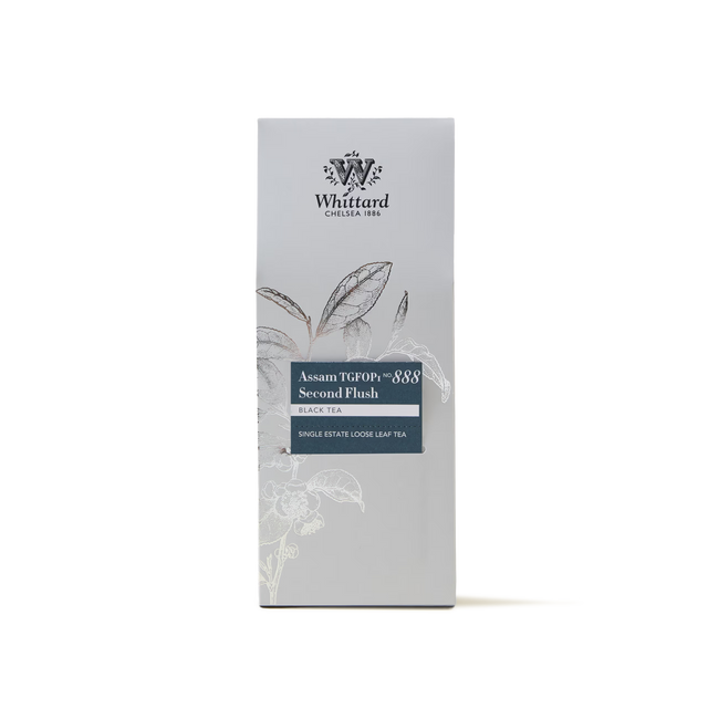 A box of Assam TGFOP1 Loose Leaf Tea, a premium black tea showcasing a floral illustration and the brand logo on a light gray background.