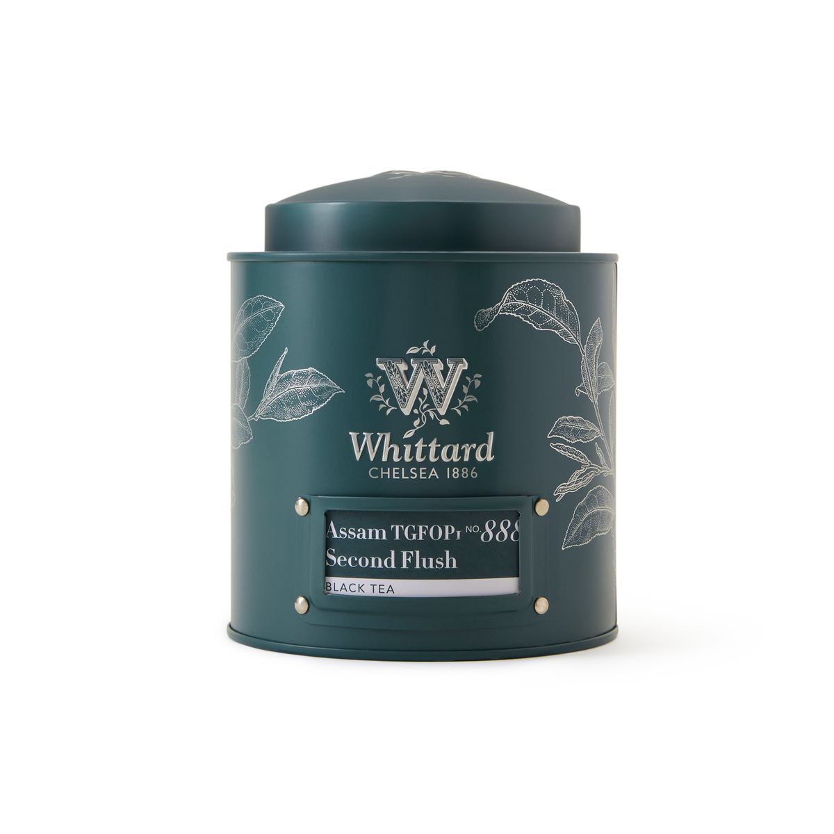 A dark green Whittard tea tin labeled Assam TGFOP1 Loose Leaf Tea, decorated with white leaf illustrations and a metallic knob on top, perfectly showcases this premium loose leaf black tea.