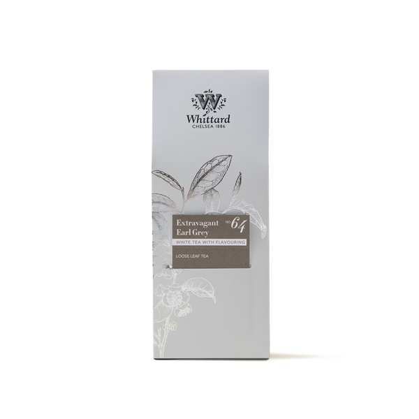 A box of Extravagant Earl Grey Loose Leaf Tea, featuring a delicate blend of white Earl Grey tea and Madagascan vanilla. The light grey packaging is adorned with a subtle tea leaf illustration and white floral accents, highlighting this exquisite loose leaf tea.