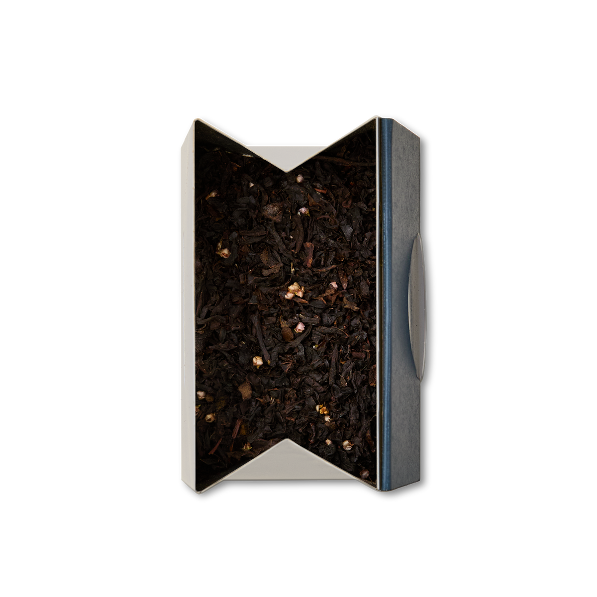 A rectangular box, open at the top and viewed from above on a white background, is filled with Whisky Loose Leaf Tea—dark Scottish black tea leaves mixed with small, light-colored pieces reminiscent of heather flowers.