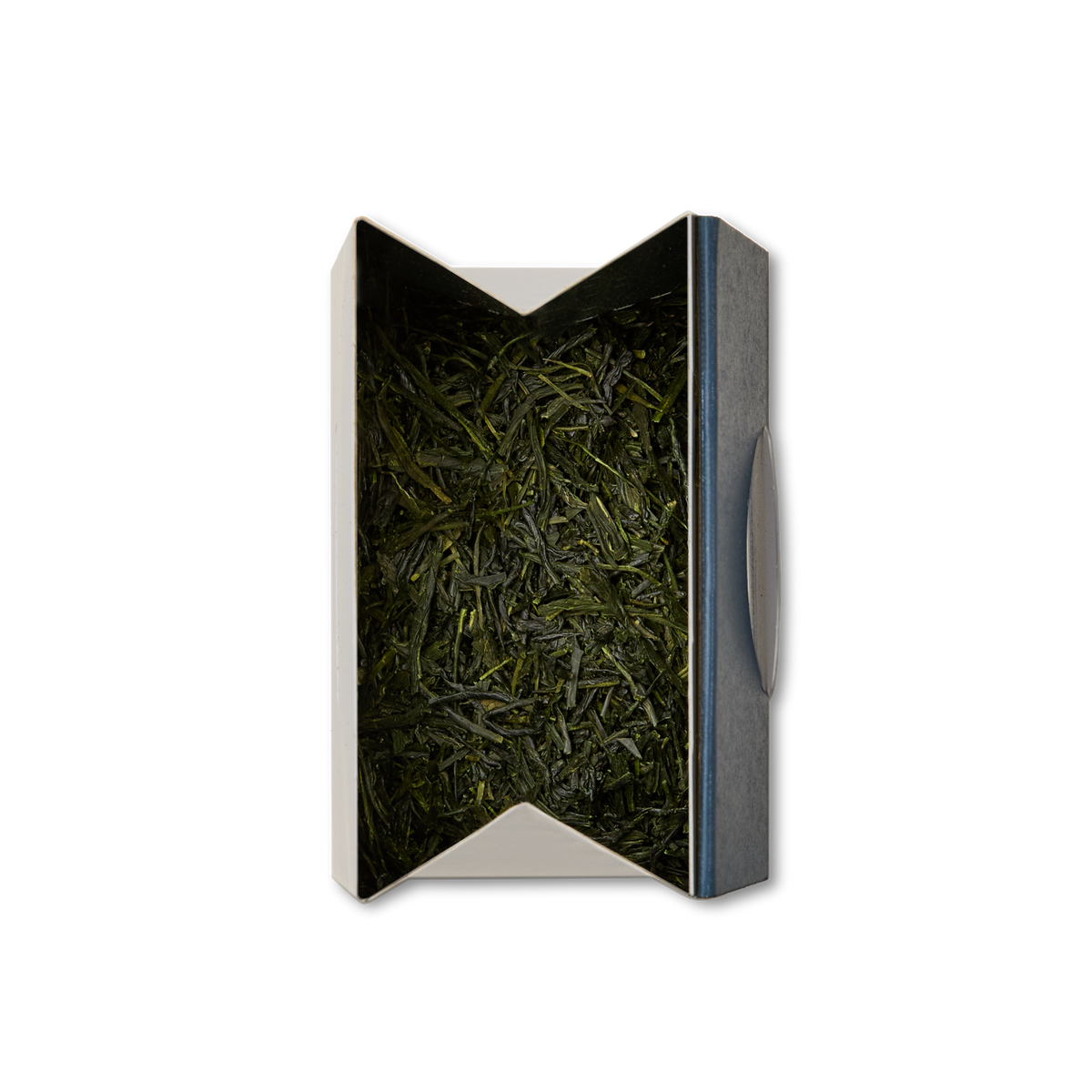 A box with a metallic edge contains Gyokuro Loose Leaf Tea—loose, dark green leaves known for their rich umami flavor—neatly packed inside and viewed from above against a white background.