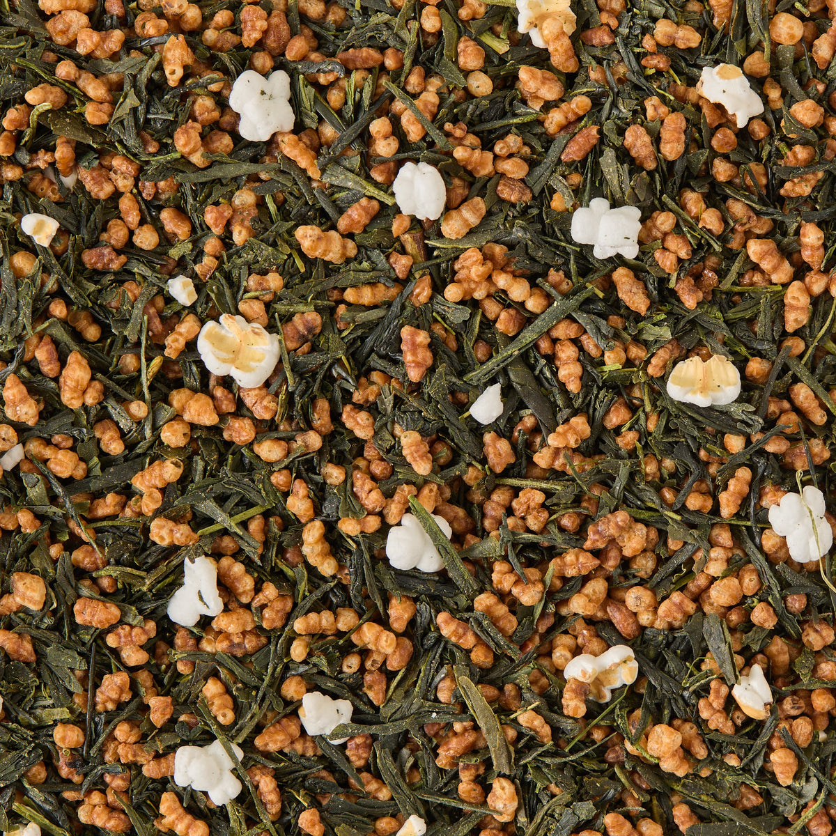 Close-up of Genmaicha Loose Leaf Tea, featuring green tea leaves blended with roasted brown rice and scattered popped rice kernels—an iconic toasted rice tea.