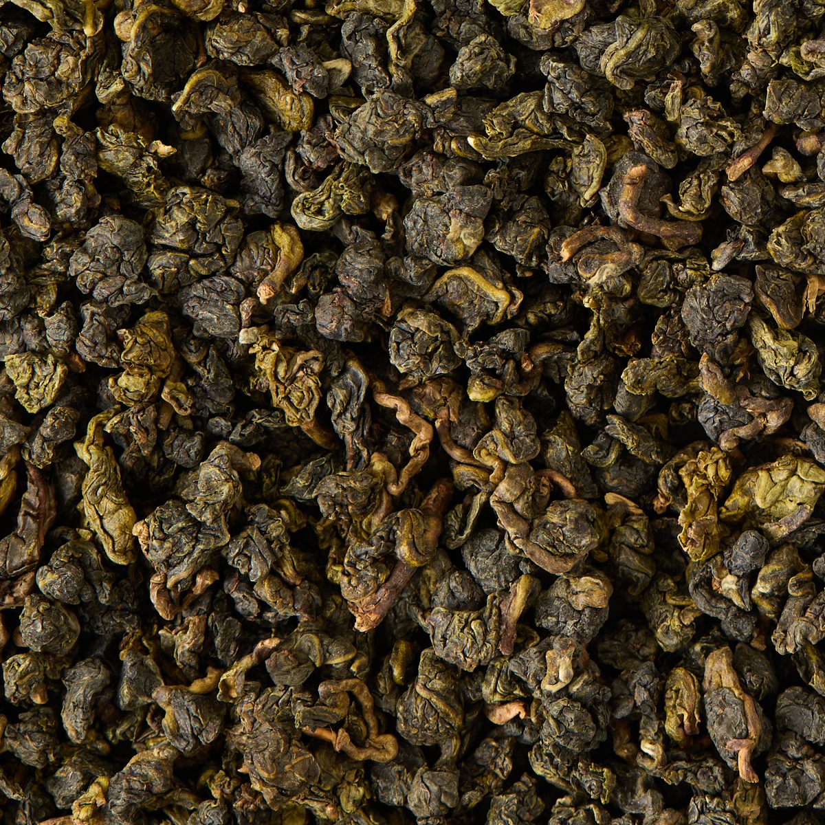 A close-up view of a pile of Jade Oolong Loose Leaf Tea, showcasing rolled leaves in varying shades of green and brown with a rough, textured surface.