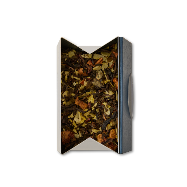 A box of Coconut Truffle Loose Leaf Tea, featuring a blend of dried leaves and fruit pieces, viewed from above on a white background.