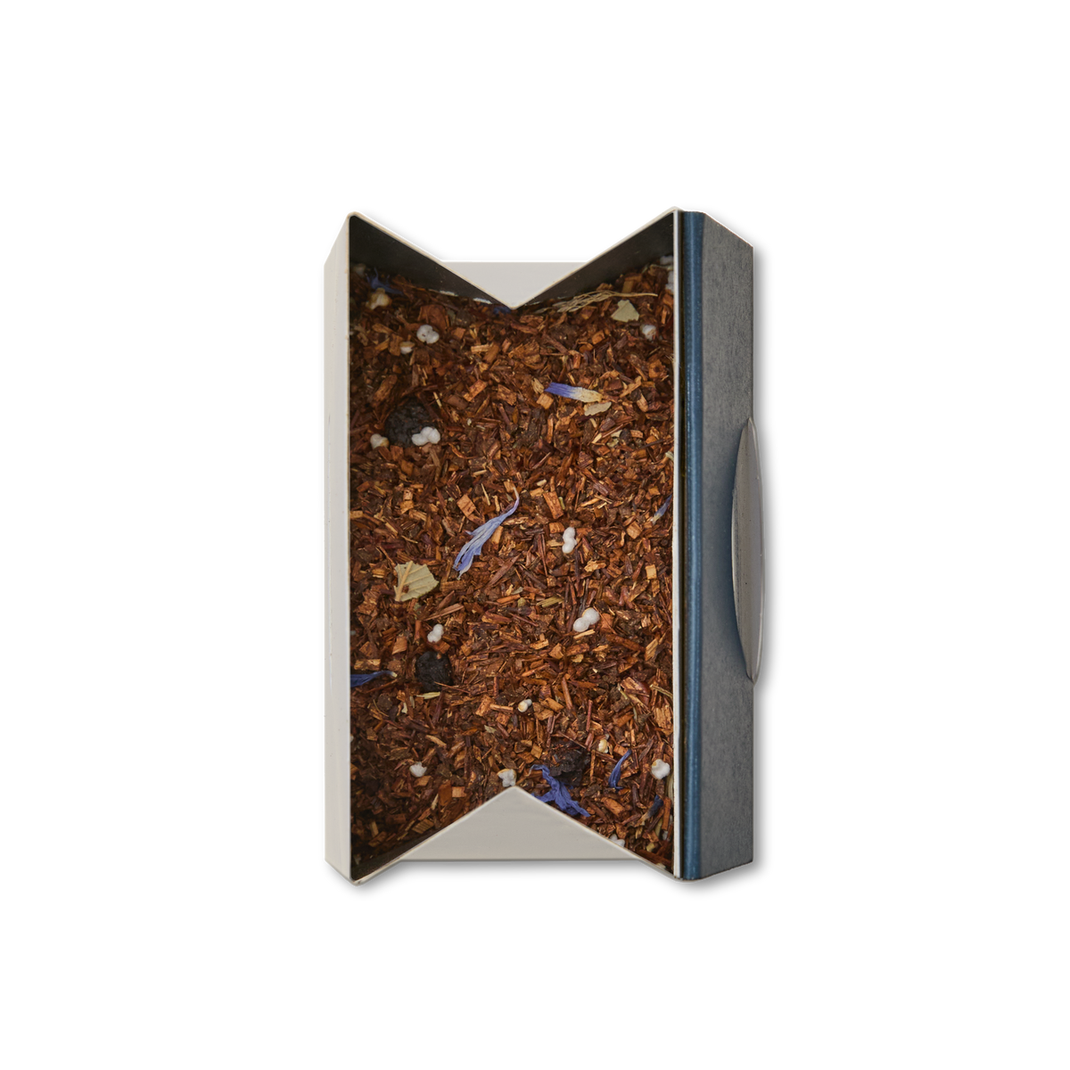 A rectangular, open-top box displays Blueberry Rooibos Loose Leaf Tea, a caffeine-free herbal blend with rooibos, flower petals, small white pieces, and hints of blueberry; the tea is viewed from above against a white background.