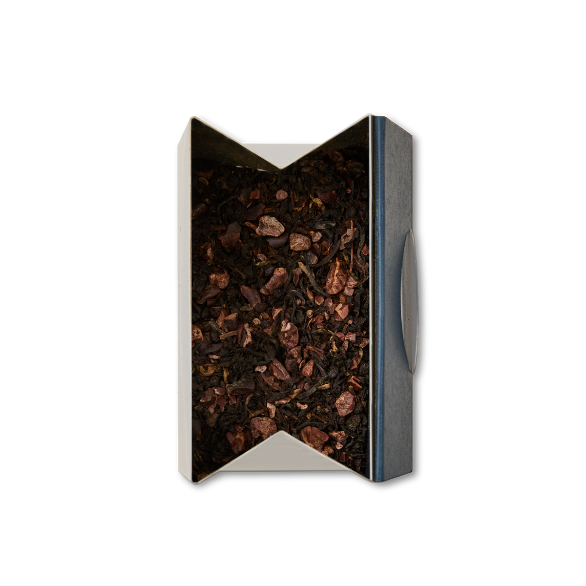 A top view of an open box of Dark Chocolate Loose Leaf Tea, featuring a blend of black tea mixed with small pieces of dried fruit and cocoa nibs, set against a white background.