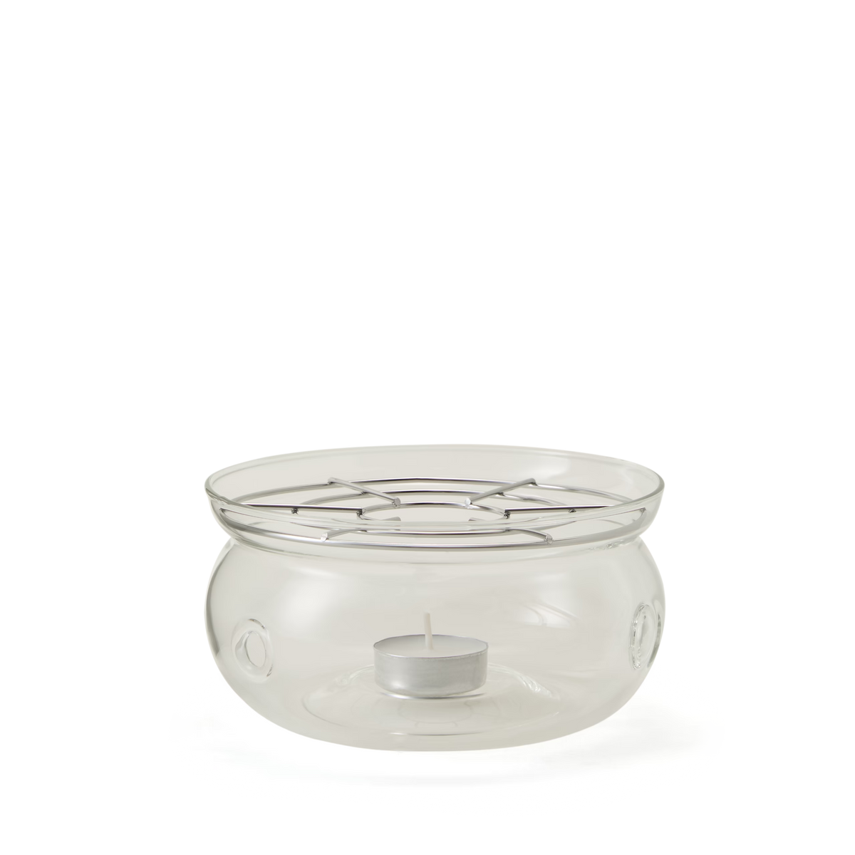 A clear glass fondue pot with a round base, open top, and metal grate above a small tealight candle holder at the bottom, used for heating or melting food items.