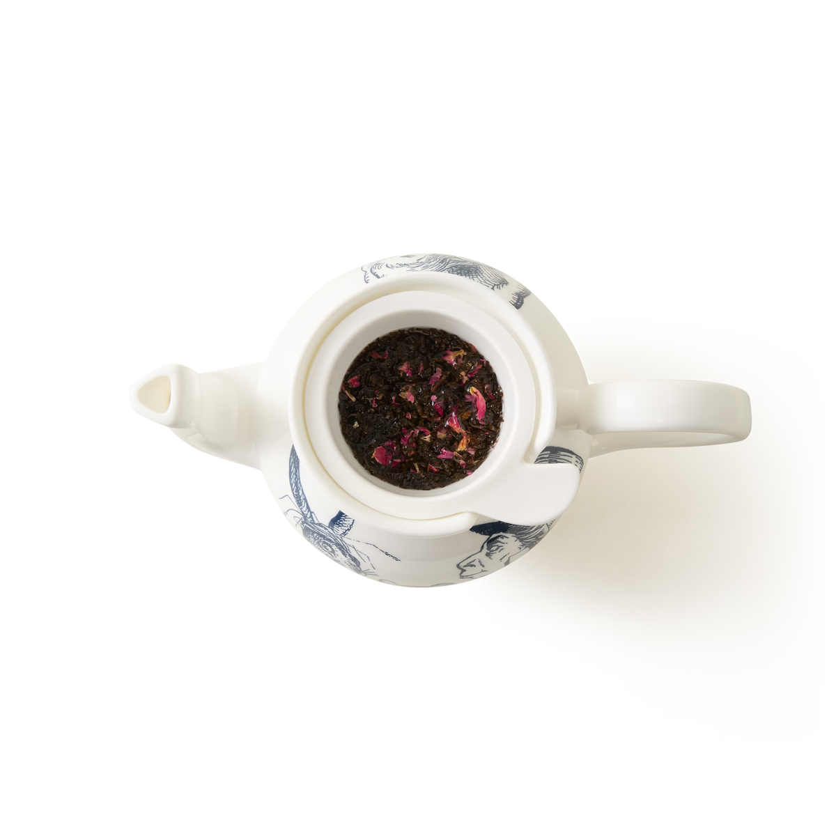 A top-down view of a white teapot with blue patterns, filled with loose leaf tea and rose petals, set against a plain white background.