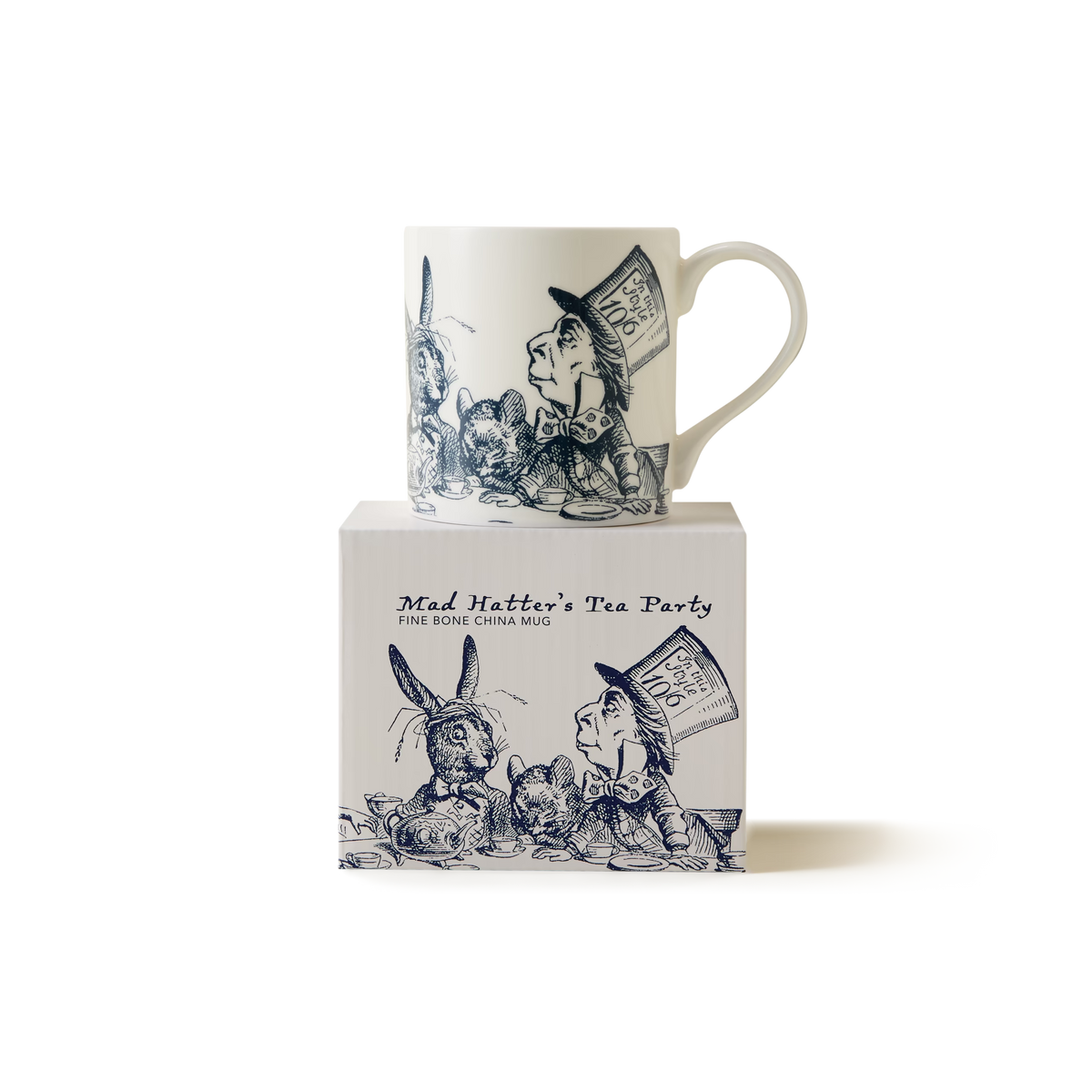 A white china mug with blue illustrations of Alice in Wonderland characters, including the Mad Hatter and the March Hare, sits on a matching box labeled Mad Hatters Tea Party..