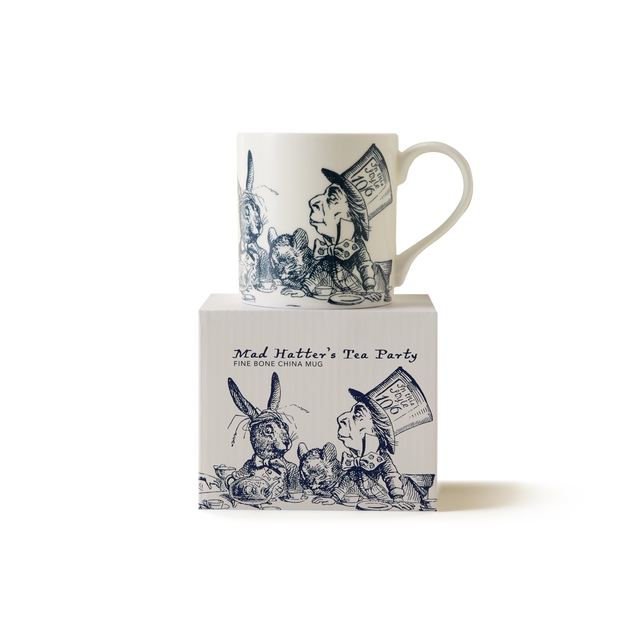A white china mug with blue illustrations of Alice in Wonderland characters, including the Mad Hatter and the March Hare, sits on a matching box labeled Mad Hatters Tea Party..