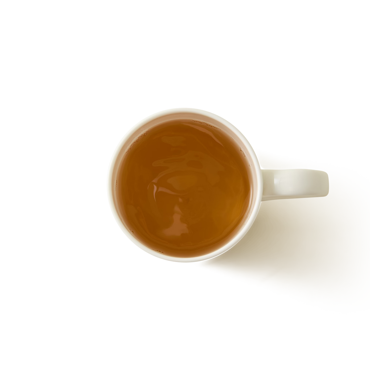 A top-down view of a white mug filled with light brown tea, set against a plain white background.