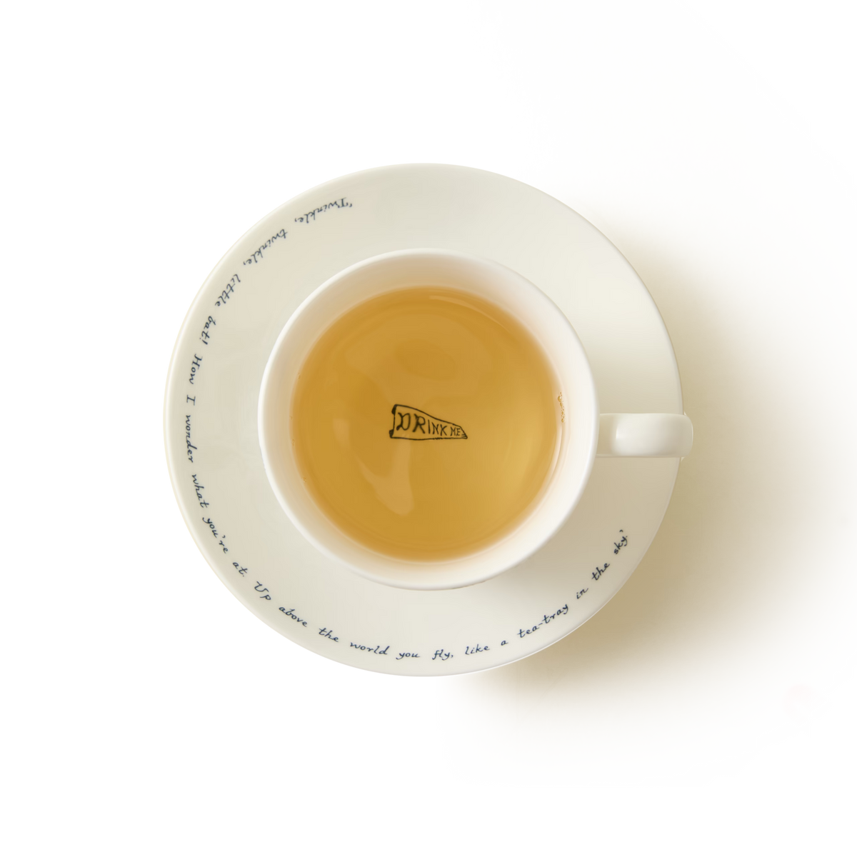 The Alice in Wonderland Cup and Saucer features a pristine white tea cup elegantly filled with tea, making it the perfect addition to any whimsical tea party. Inside the cup, you’ll find a playful shark fin illustration accompanied by the word “DRINK,” while graceful cursive writing encircles the edge of the matching saucer. Set against a pure white background, this charming design brings a touch of magic to your teatime.