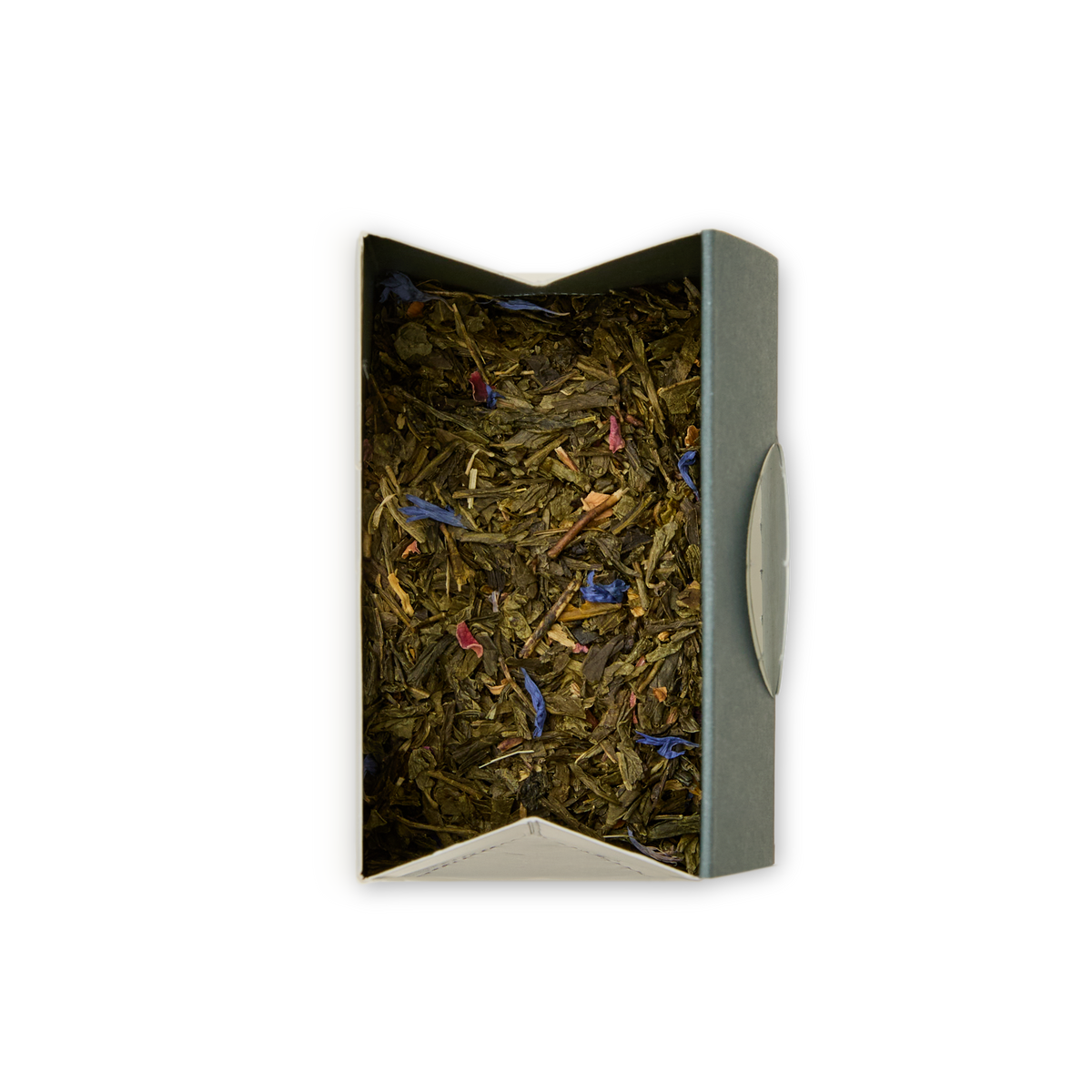 An open rectangular box of Mango & Bergamot Loose Leaf Tea, filled with vibrant green tea leaves blended with small blue and pink flower petals and a hint of mango bergamot, viewed from above against a plain white background.