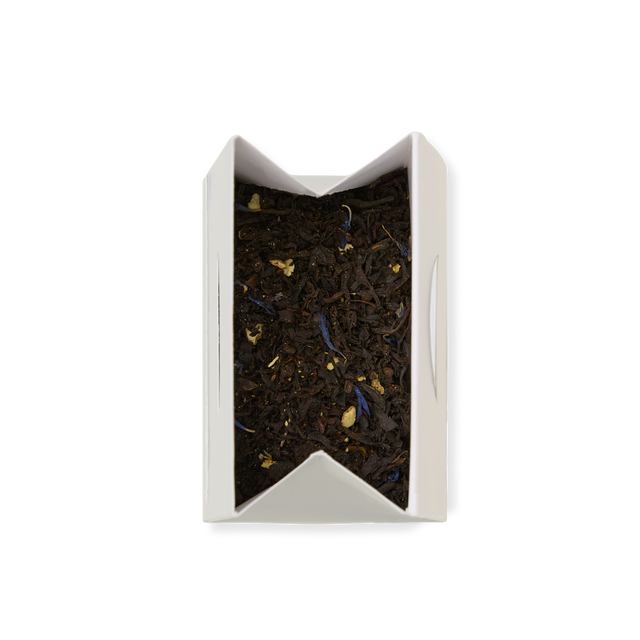 A rectangular white box of Earl Grey Loose Leaf Tea, featuring loose black tea leaves with visible blue and yellow flower petals and notes of bergamot, viewed from above against a white background.