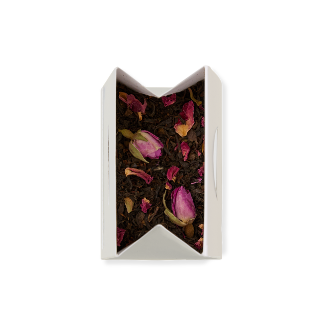 A white rectangular box of English Rose Loose Leaf Tea, featuring a blend of loose leaf tea with pink rose buds and petals, is viewed from above on a plain white background.