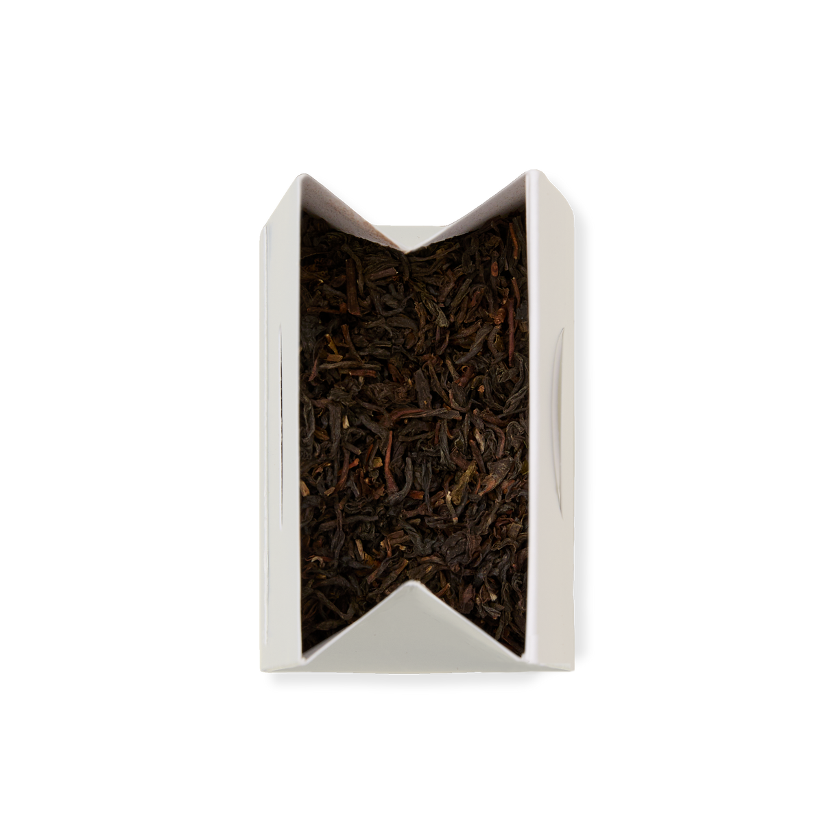 An open rectangular white box of Darjeeling Loose Leaf Tea, filled with loose black tea leaves and viewed from above on a plain white background.