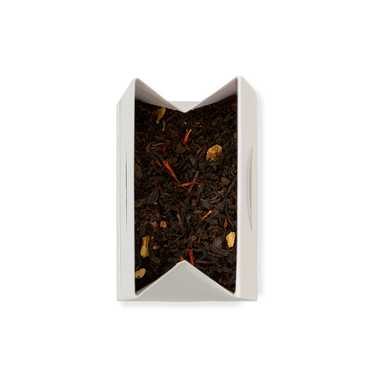 A partially opened white paper box of Spice Imperial Loose Leaf Tea reveals a blend of black tea leaves mixed with small pieces of dried ginger and red saffron threads, viewed from above on a white background.