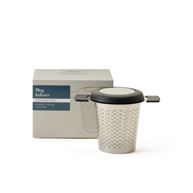A stainless steel mug infuser with a black rim and handles is shown next to its packaging box, which has an image and description of the product on a light background.