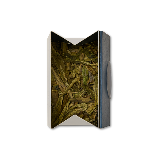Open box containing Dragon Well Loose Leaf Tea, viewed from above against a white background.