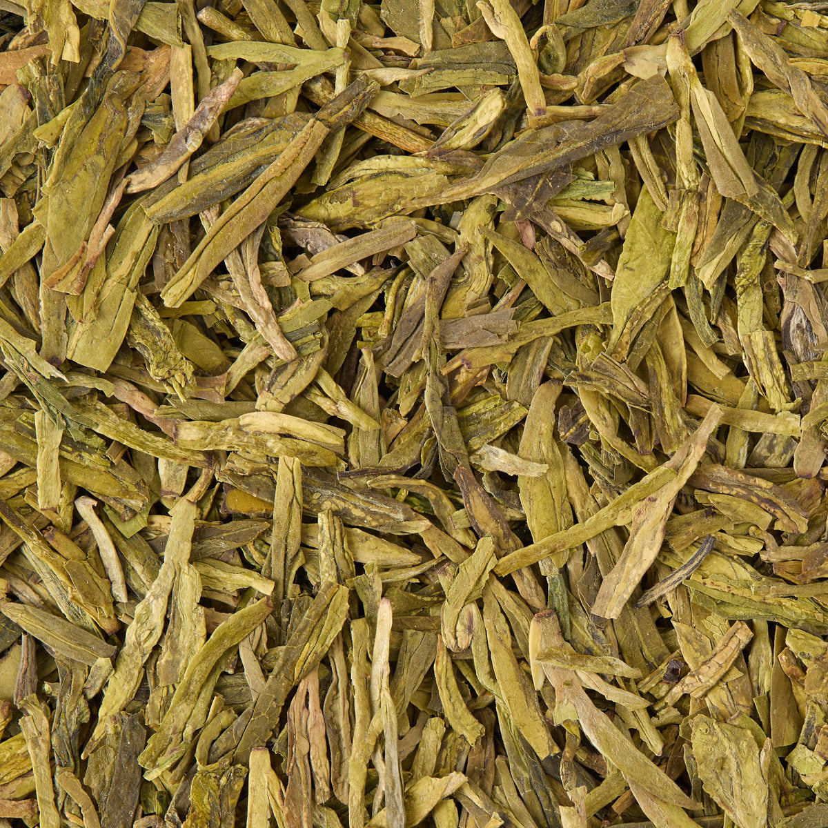 Close-up view of Dragon Well Loose Leaf Tea, displaying flat, long, and slightly twisted dried leaves in various shades of green and brown.