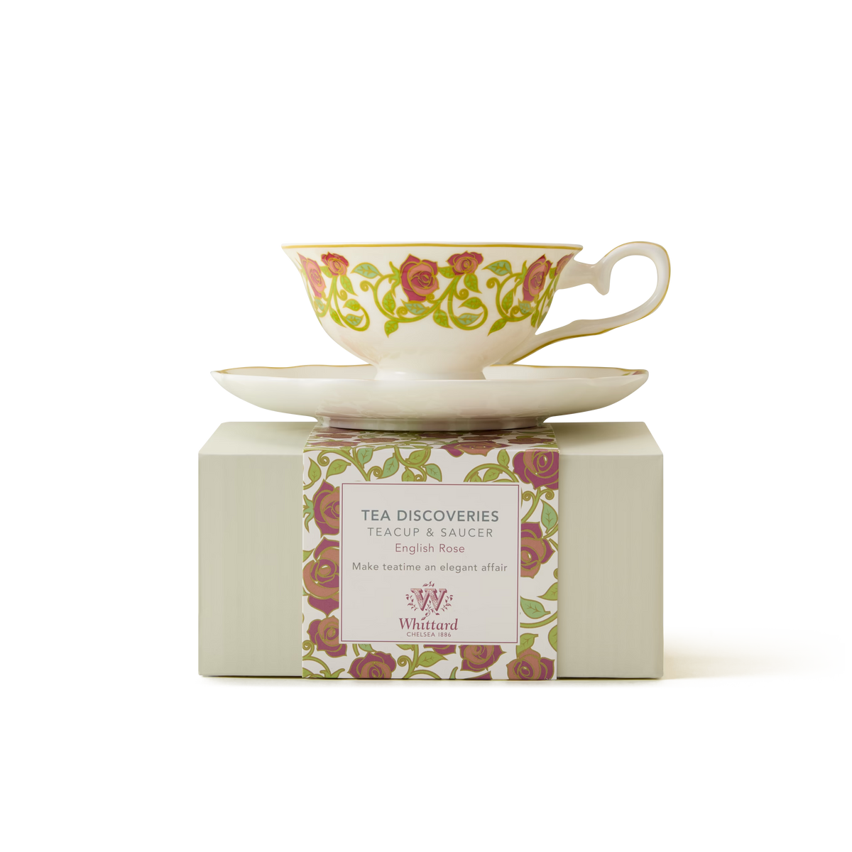 An English Rose Tea Cup and Saucer, crafted from fine bone china, rests atop a striped box. Both the cup and the packaging feature delicate rose motifs embellished with elegant gold trim—ideal for enjoying your favorite tea in style.