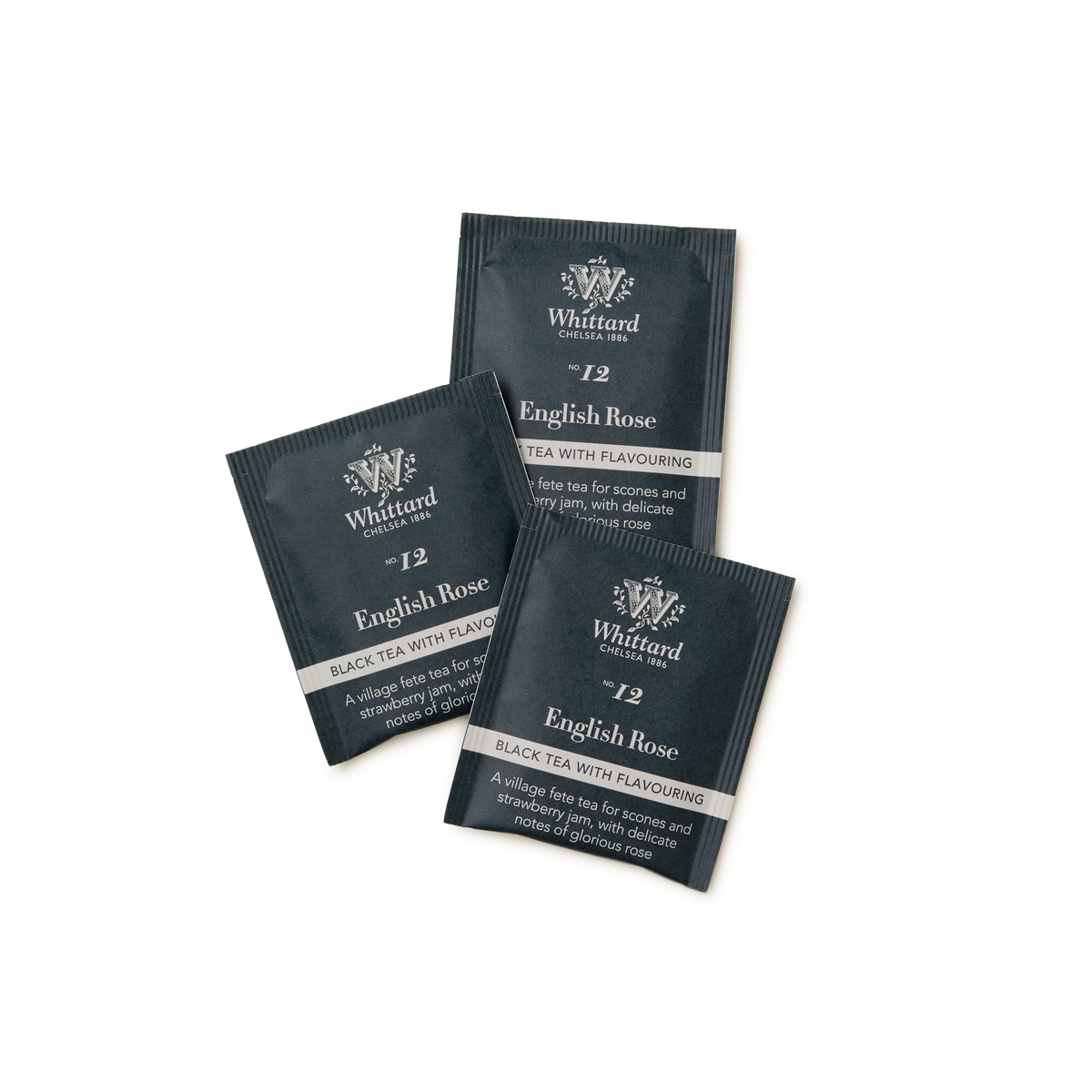 Three dark grey English Rose Teabags are arranged on a white background. The packaging features white text displaying the product name and details, complemented by subtle floral designs.