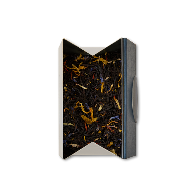 An open box of Covent Garden Blend Loose Leaf Tea, with colorful flower petals mixed among dark tea leaves, viewed from above on a white background.