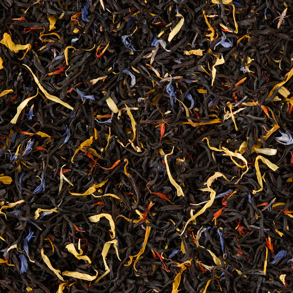 A close-up of Covent Garden Blend Loose Leaf Tea showcases a textured and vibrant mixture of black tea leaves with colorful flower petals—including shades of yellow, blue, and red.