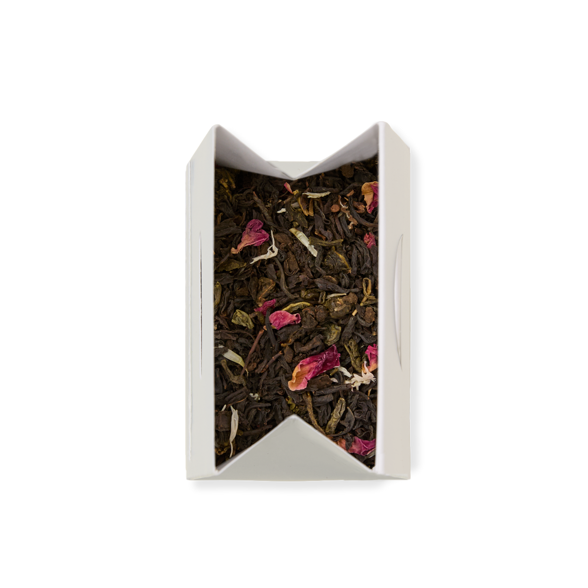 Afternoon Tea Loose Leaf Tea blend with rose petals and green leaves inside an open white paper tea sachet, viewed from above on a white background—perfect for elevating your afternoon tea with its fragrant oolong and jasmine green tea notes.