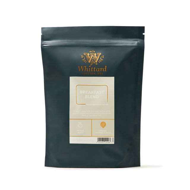 A dark green bag of Whittard Breakfast Blend Coffee stands upright, adorned with gold and cream labeling that displays the Whittard logo, product name, and blend details against a plain white background. Expertly crafted as a medium roast from select Brazilian and Colombian coffee beans, this blend offers a rich, balanced flavor in every cup.