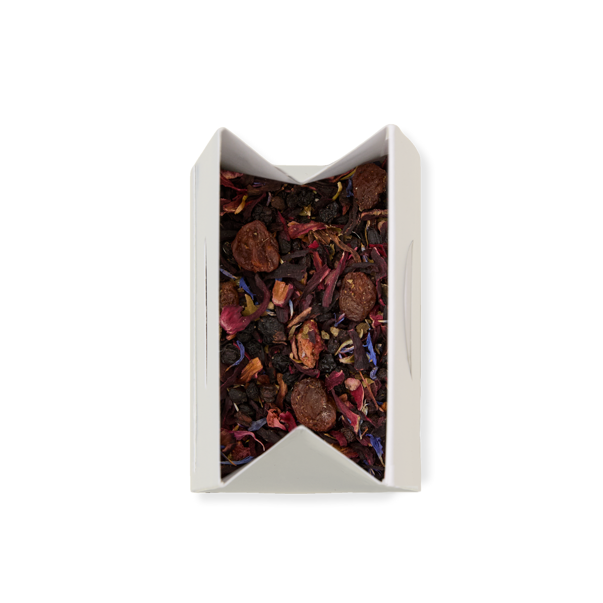 A white box of Very Berry Crush Loose Infusion, filled with loose leaf tea blended with dried fruit pieces and vibrant flower petals, viewed from above on a white background.