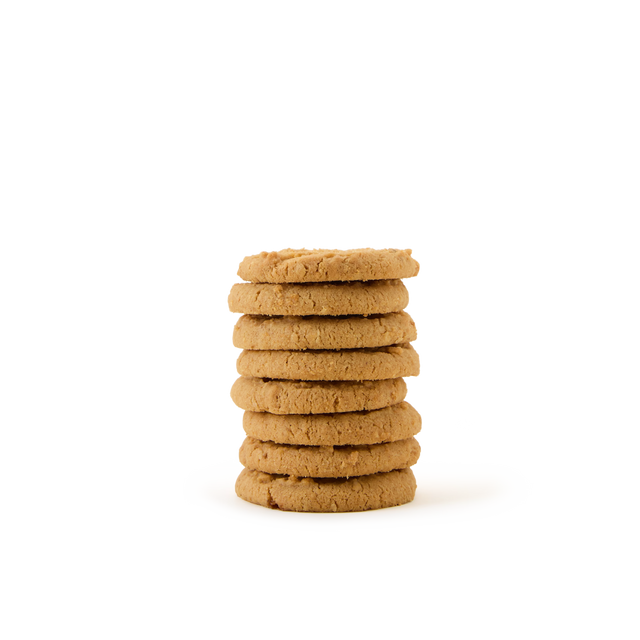 A stack of seven round, golden-brown cookies is arranged neatly on a plain white background.