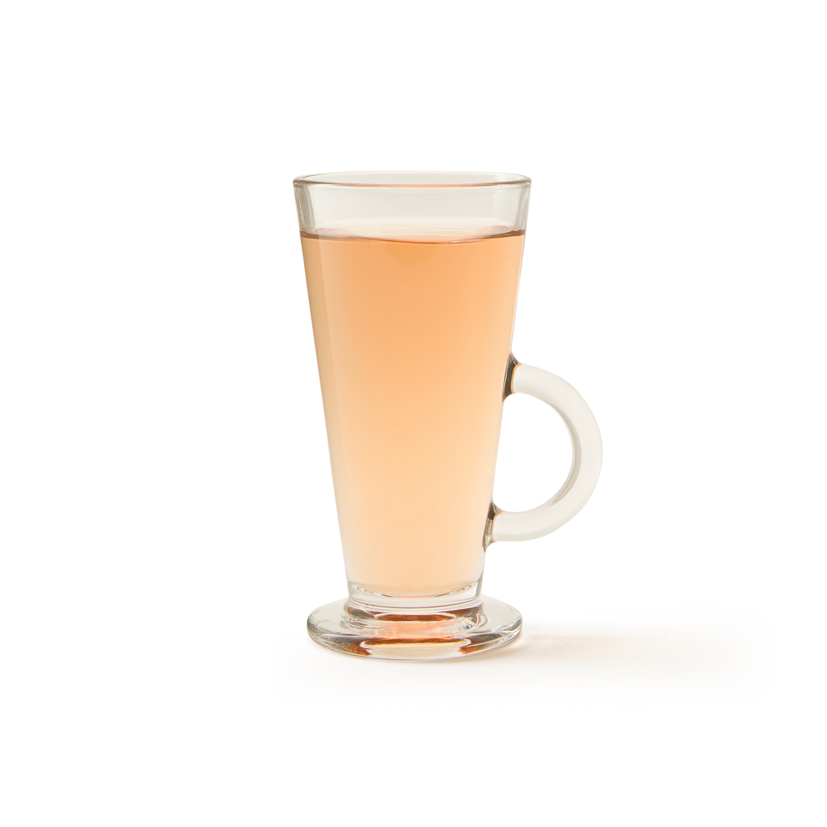 The SoHo Glass, a clear and durable soda glass mug with a handle, filled with light amber-colored tea and set against a plain white background, evokes the simple elegance of cafe-style glassware.