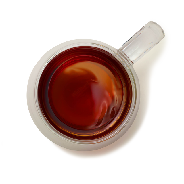 Top-down view of a Nova Double-Walled Mug made from borosilicate glass, filled with dark tea or coffee on a white background. The handle is positioned on the right, and the liquid appears smooth with subtle reflections.