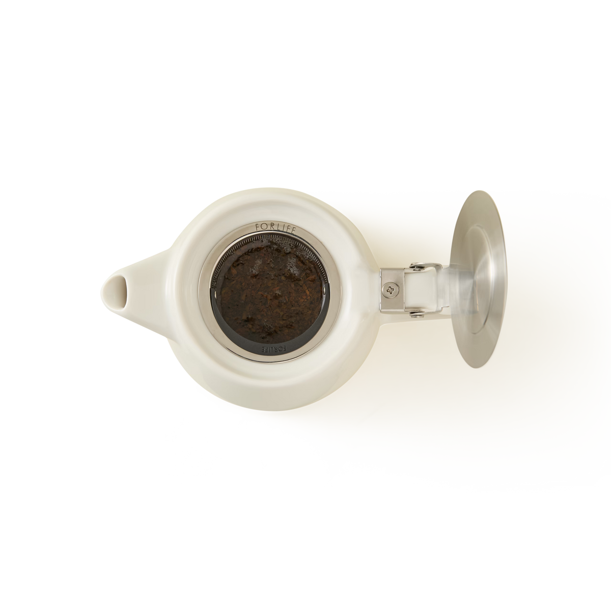 Top view of a white teapot with its lid open, revealing a metal infuser filled with brewed tea leaves. The teapot is placed against a plain white background.