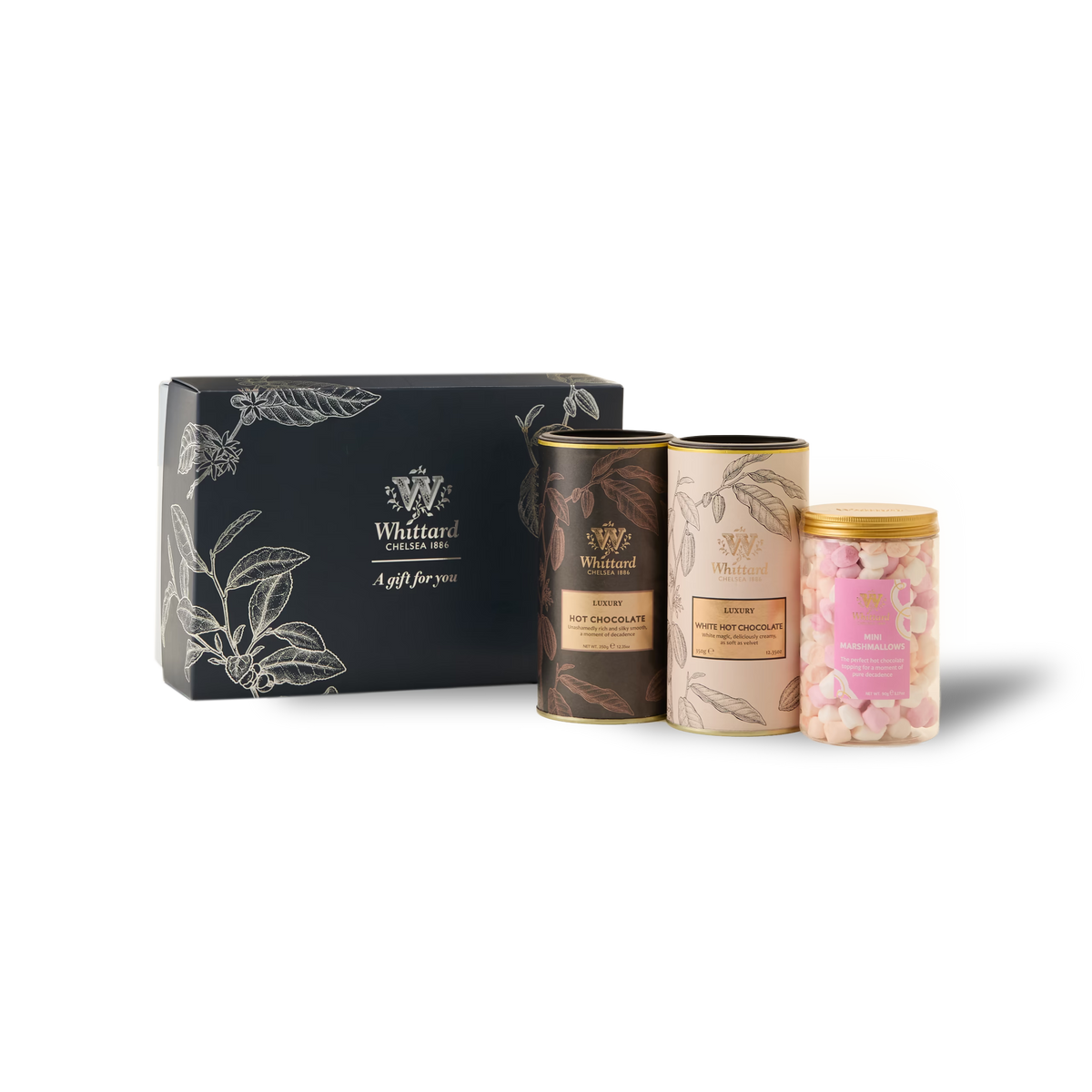 The Luxury Hot Chocolate Gift Box features a dark box containing two tins labeled Hot Chocolate and Luxury White Hot Chocolate, along with a jar filled with pink and white mini marshmallows. All items are neatly arranged on a white background.