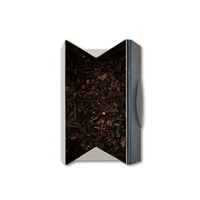 An open rectangular box of Peach Oolong Loose Leaf Tea, viewed from above against a white background. The box features white sides with a dark blue edge and is filled with aromatic tea leaves inside.