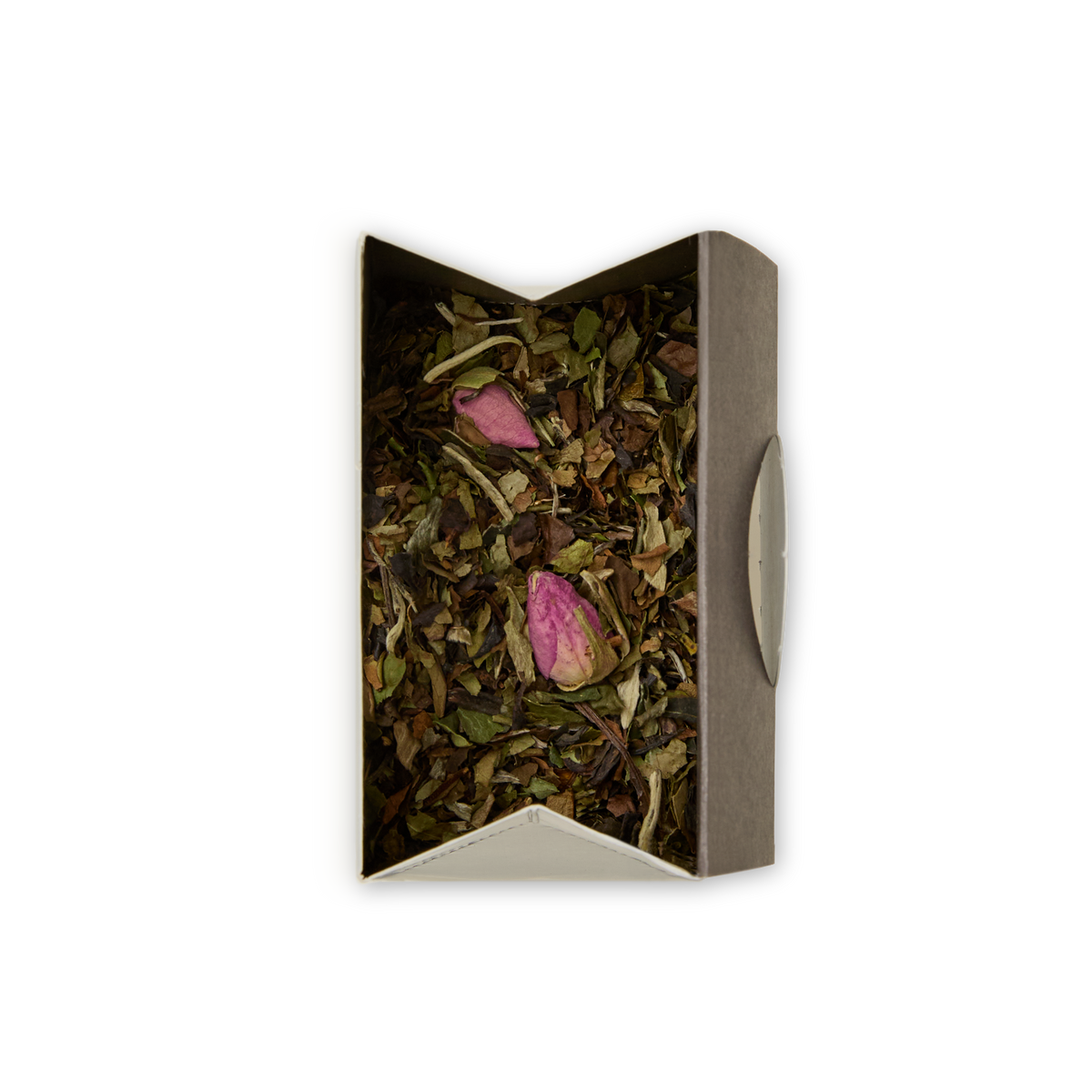 A box of Chelsea Garden Loose Leaf Tea, featuring dried white peony tea leaves and two pink rosebuds, viewed from above against a white background for an elegant floral tea experience.