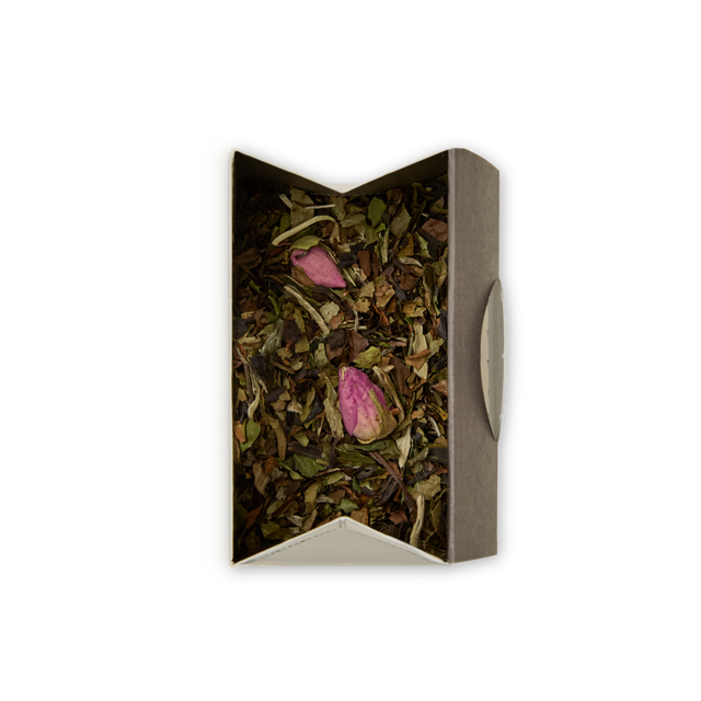 A box of Chelsea Garden Loose Leaf Tea, featuring dried white peony tea leaves and two pink rosebuds, viewed from above against a white background for an elegant floral tea experience.