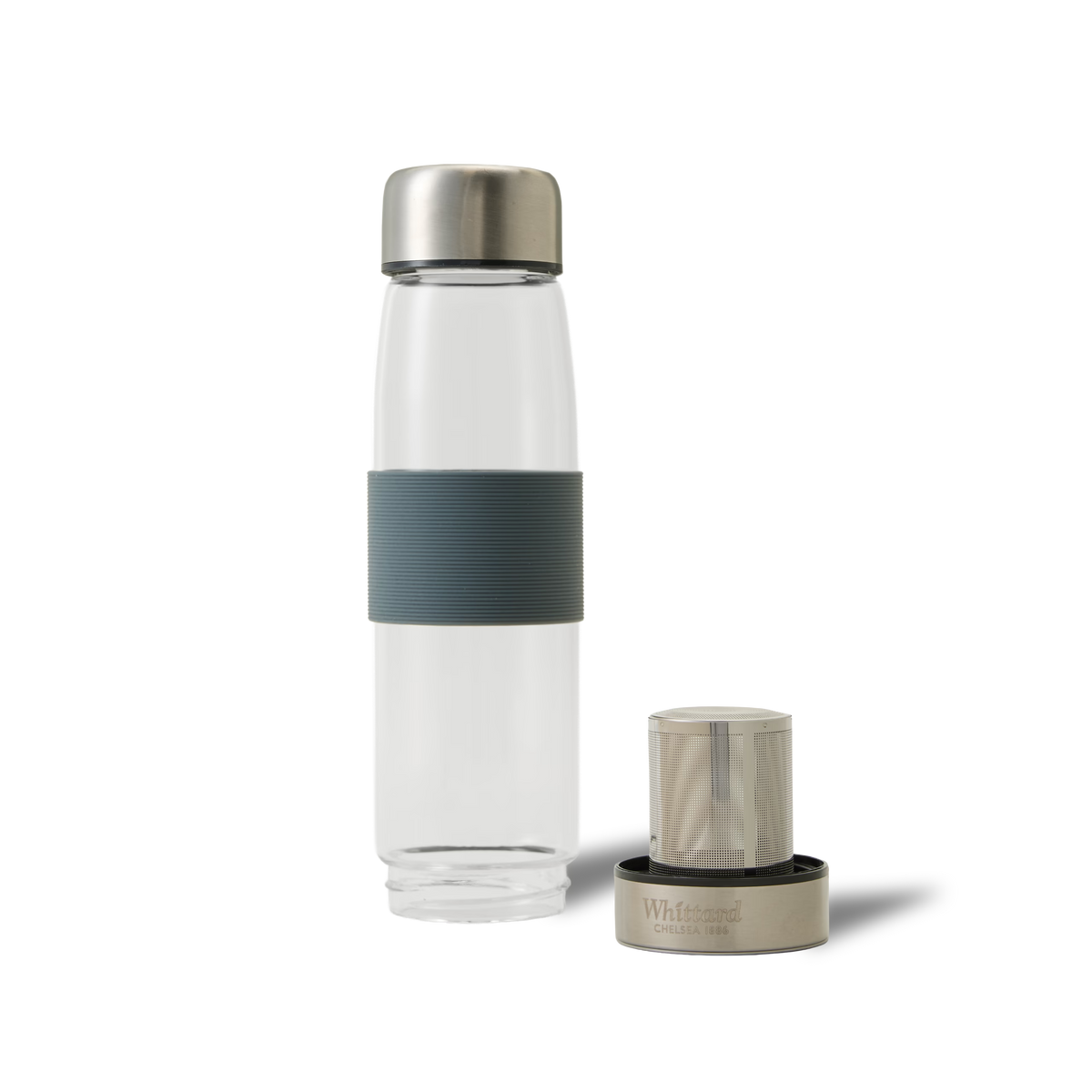 A clear glass water bottle with a grey grip band and silver cap stands upright next to a detached infuser with a matching silver top, both on a plain white background.