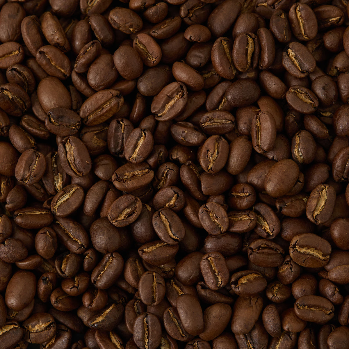 A close-up view of Ethiopia Yirgacheffe Coffee beans reveals their rich dark brown color and textured surfaces—a true showcase of specialty coffee at its finest.