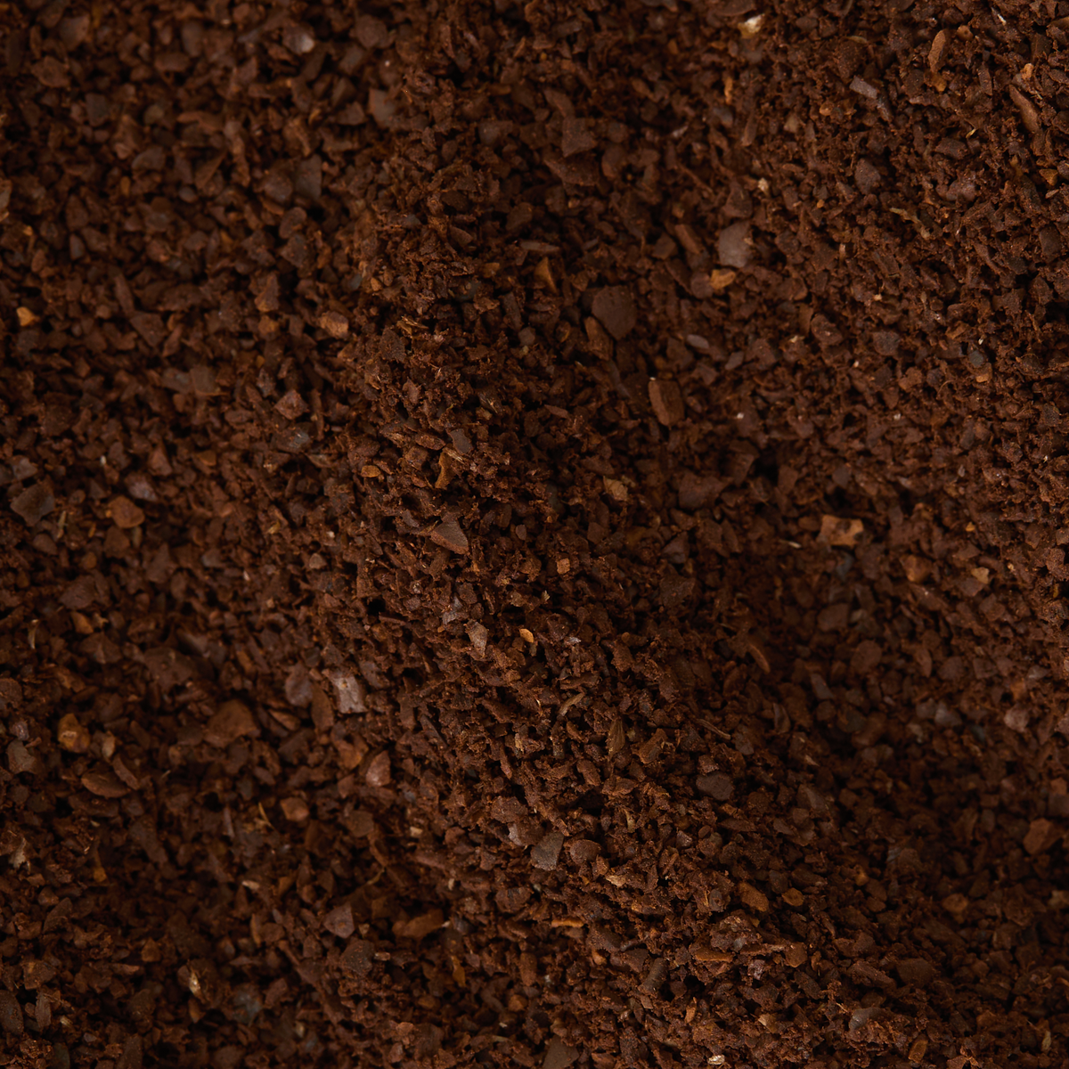 Here’s your rewritten sentence using the product data: A close-up view of Sumatra Mandheling Coffee, highlighting its dark brown hue and coarse texture—attributes shaped by wet-hulling, which imparts this coffee’s characteristic low acidity.