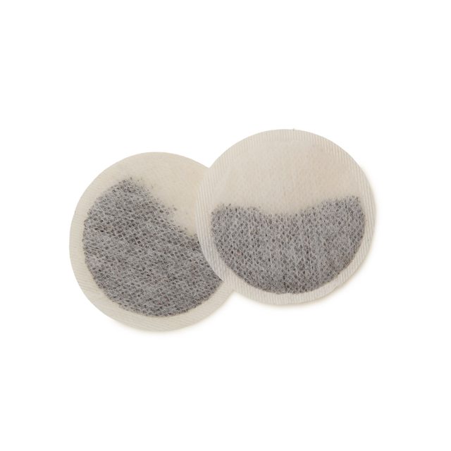 Two round Darling Grey Teabags with a visible mesh texture, one slightly overlapping the other, both filled with loose Earl Grey tea leaves inside, displayed on a plain white background.