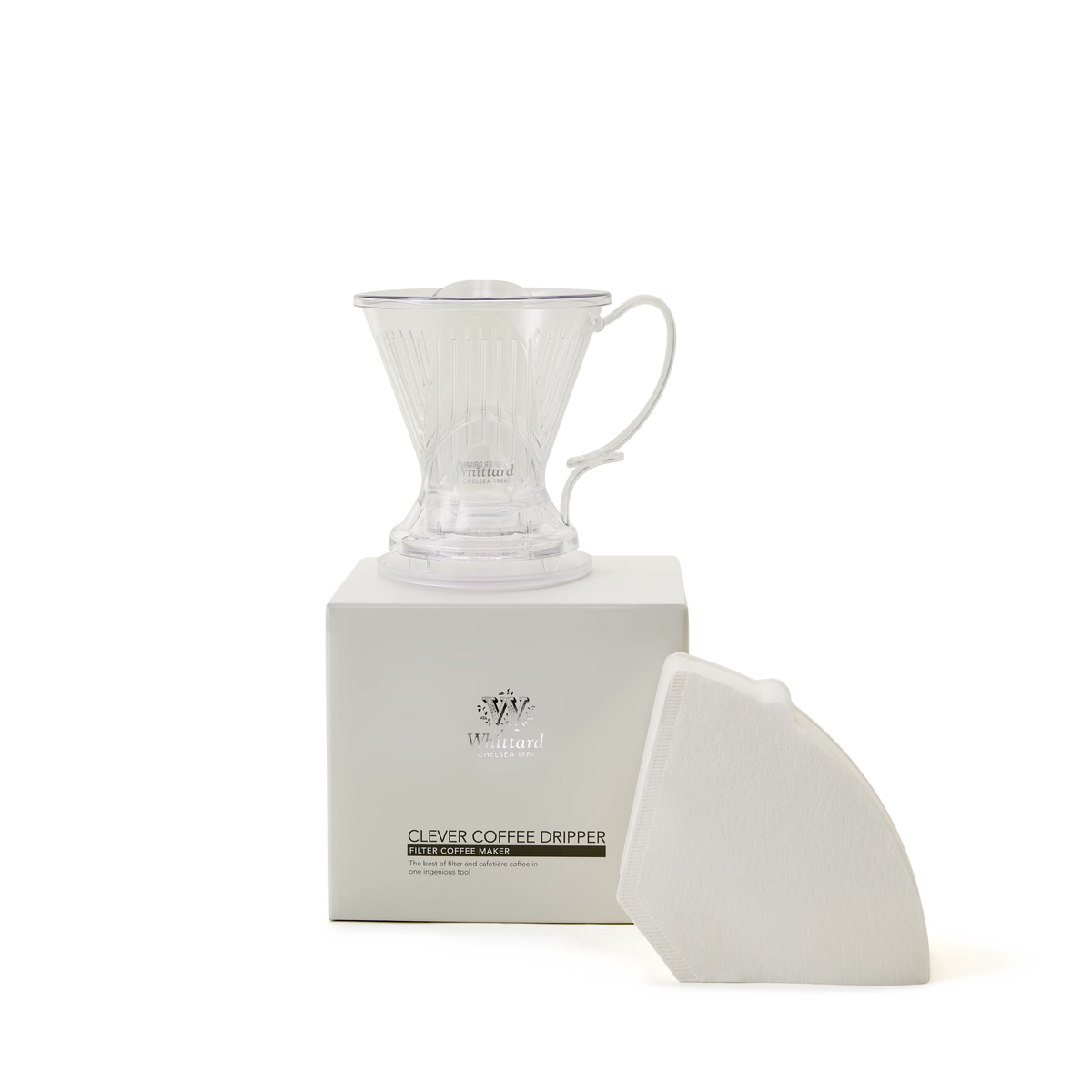 A transparent plastic coffee dripper sits on a white box labeled Clever Coffee Dripper, with a stack of white paper filters leaning against the box, all on a plain white background.