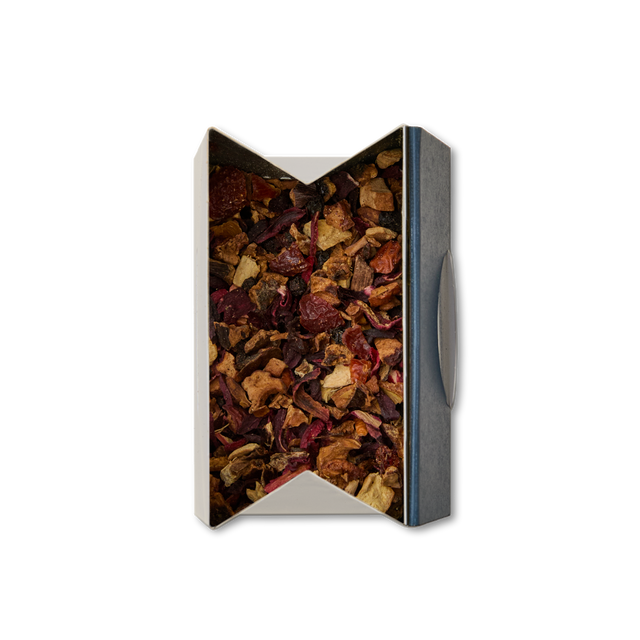 A rectangular box with a window reveals Berry Elixir Loose Infusion—a vibrant mix of dried tea leaves and fruit pieces in red, brown, and orange hues—set against a white background.