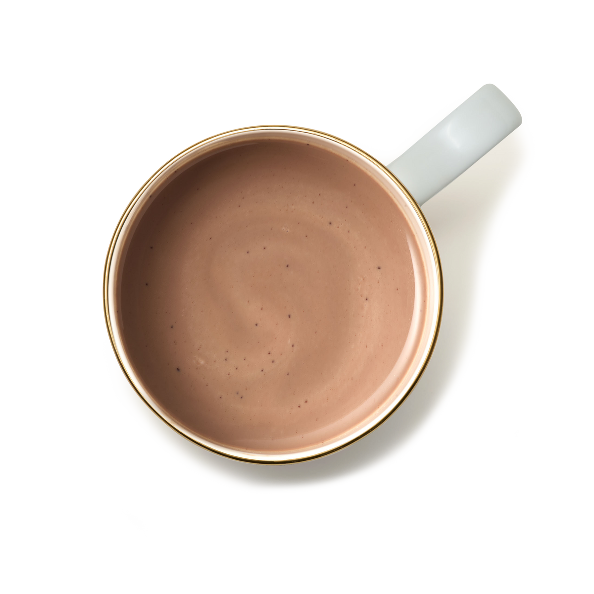 A top-down view of a white ceramic cup with a gold rim, filled with Luxury Hot Chocolate in a light brown hue, set against a plain white background.
