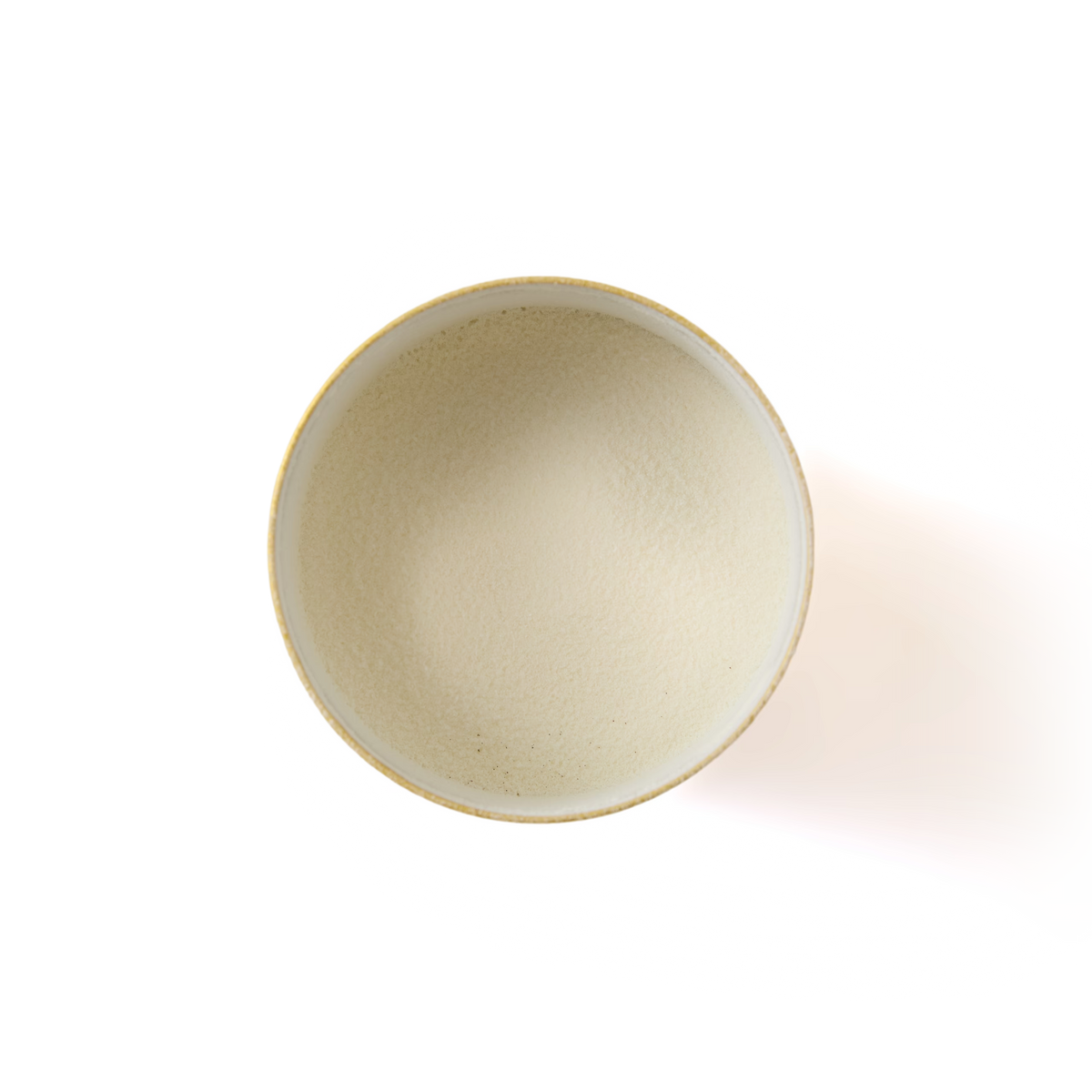 A top-down view of a bowl filled with Luxury White Hot Chocolate powder—a fine, light beige blend—on a white background, perfect for preparing a creamy and indulgent hot chocolate.