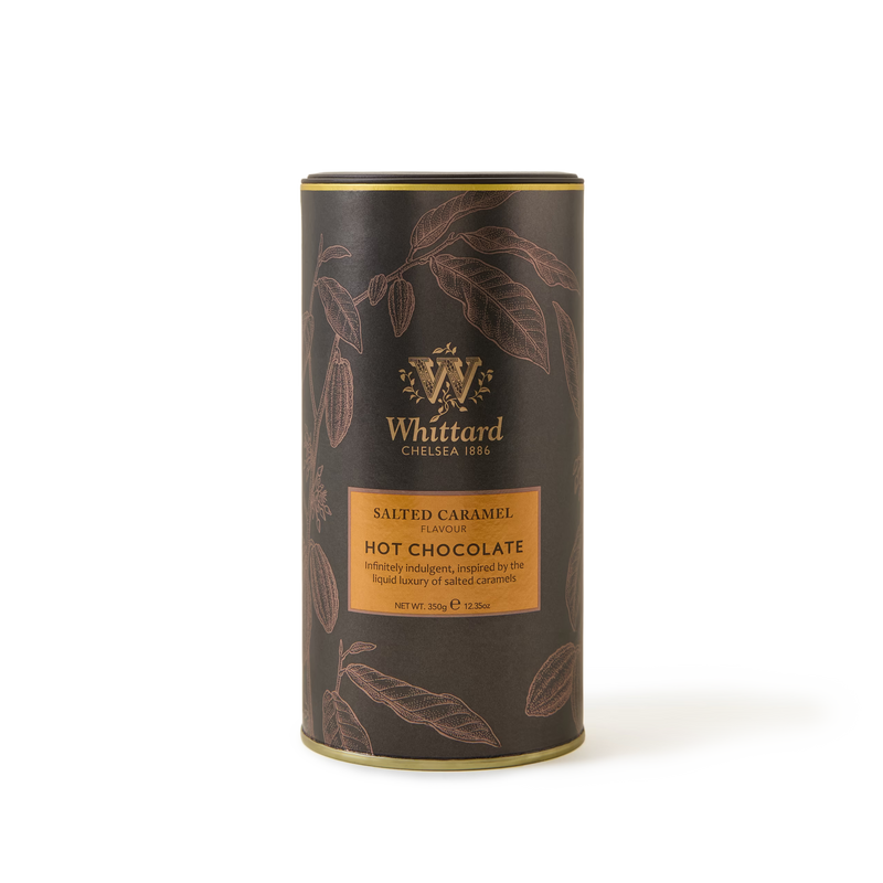 A cylindrical tin of Whittard Salted Caramel Hot Chocolate, with a dark brown design, gold accents, and illustrations of cocoa pods. Label reads Salted Caramel Flavour Hot Chocolate..